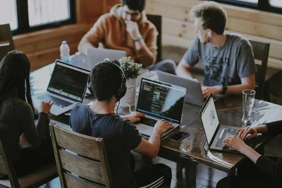 Equipo trabajando en conjunto con computadoras portátiles